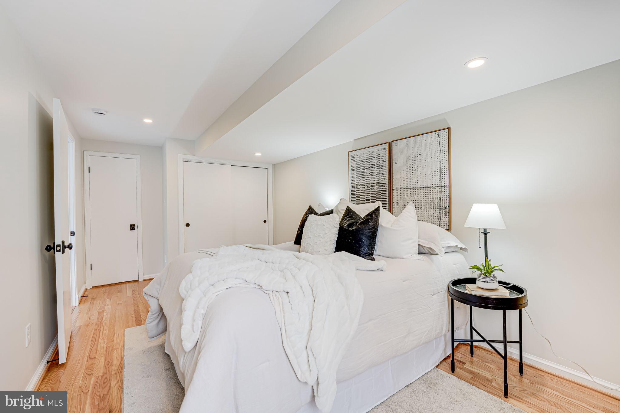 7401 Fort Hunt Road Alexandria, VA 22307 - Photo 47 of 56 a bedroom with a bed and a lamp