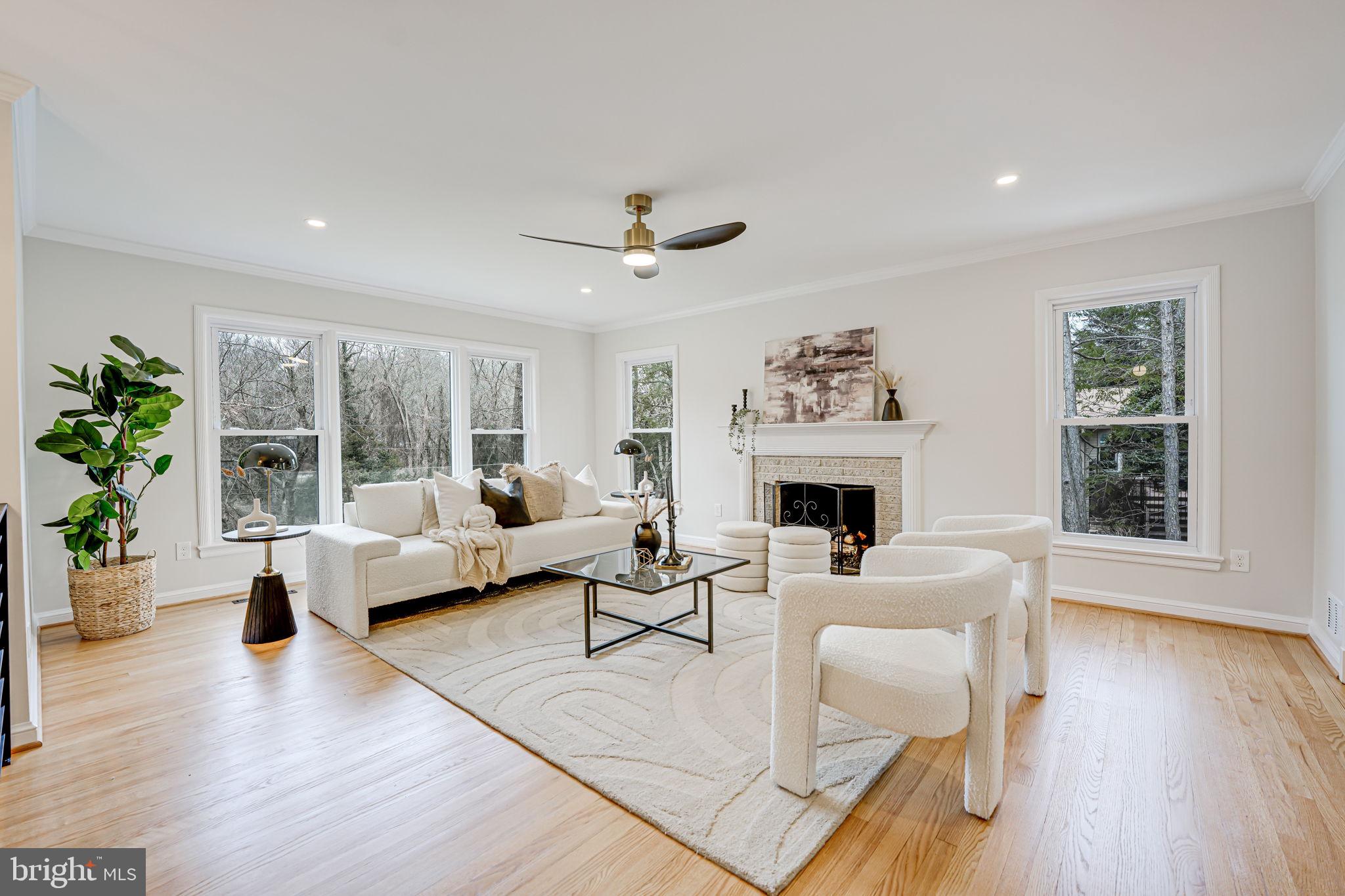 7401 Fort Hunt Road Alexandria, VA 22307 - Photo 6 of 56 a living room with furniture a fireplace and a large window