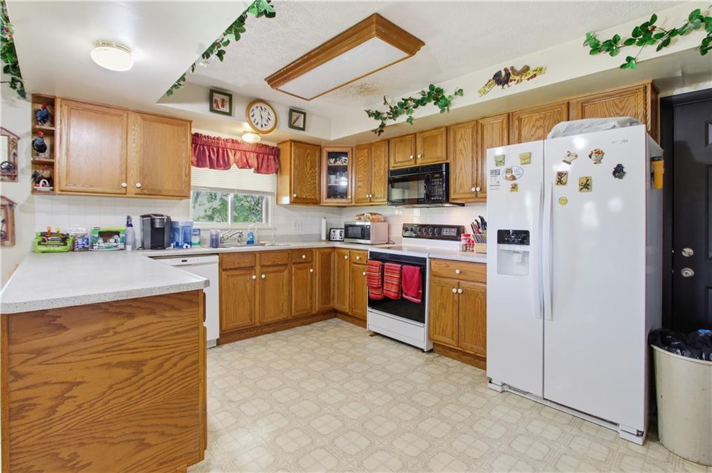 776 Fraction Road West Finley, PA 15377 - Photo 17 of 43 a kitchen with stainless steel appliances granite countertop a refrigerator sink and microwave