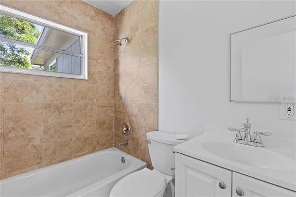 a bathroom with a sink toilet and vanity