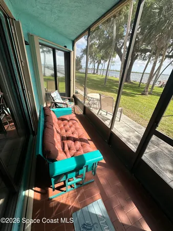 a room with large windows and bed