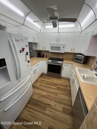 a kitchen with stainless steel appliances granite countertop a sink and cabinets