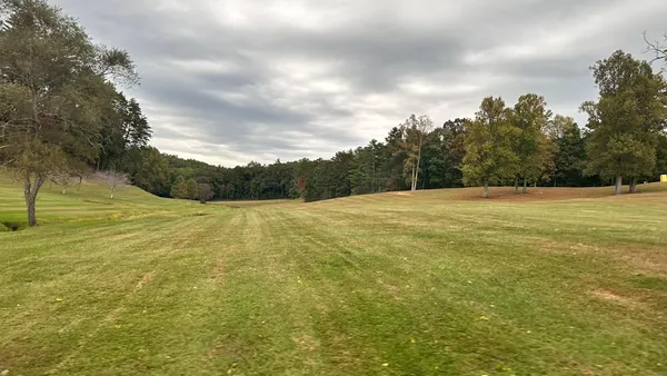 a living room with a fireplace windows and a fireplace