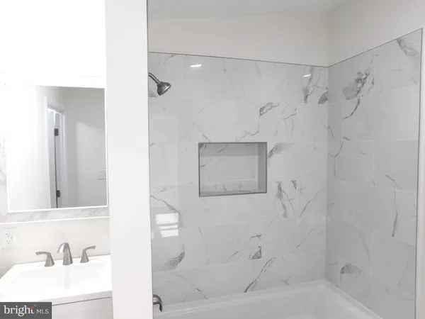 a bathroom with a bathtub and a sink