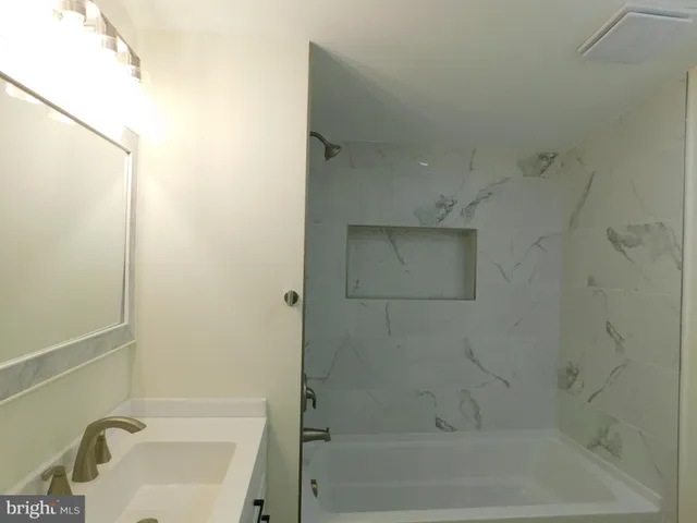 a bathroom with a sink and mirror