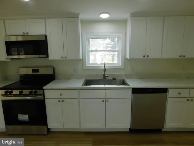a kitchen with a sink and a microwave