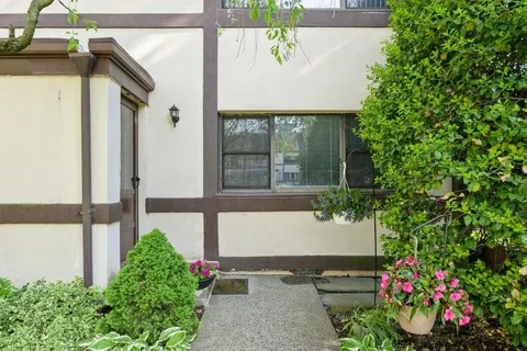 a view of a house with a flower garden