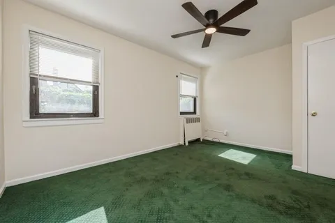 a view of a room with window and ceiling fan