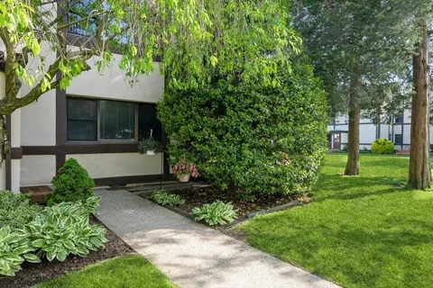 a front view of a house with garden