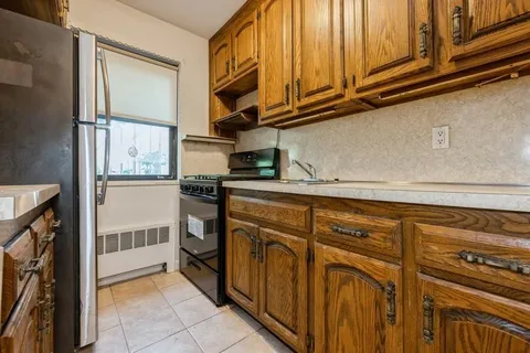a kitchen with stainless steel appliances granite countertop a refrigerator and cabinets