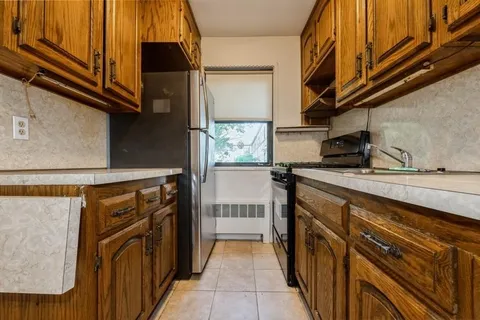 a kitchen with stainless steel appliances granite countertop a refrigerator and a stove