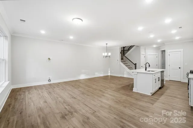 a view of kitchen with kitchen island and stainless steel appliances