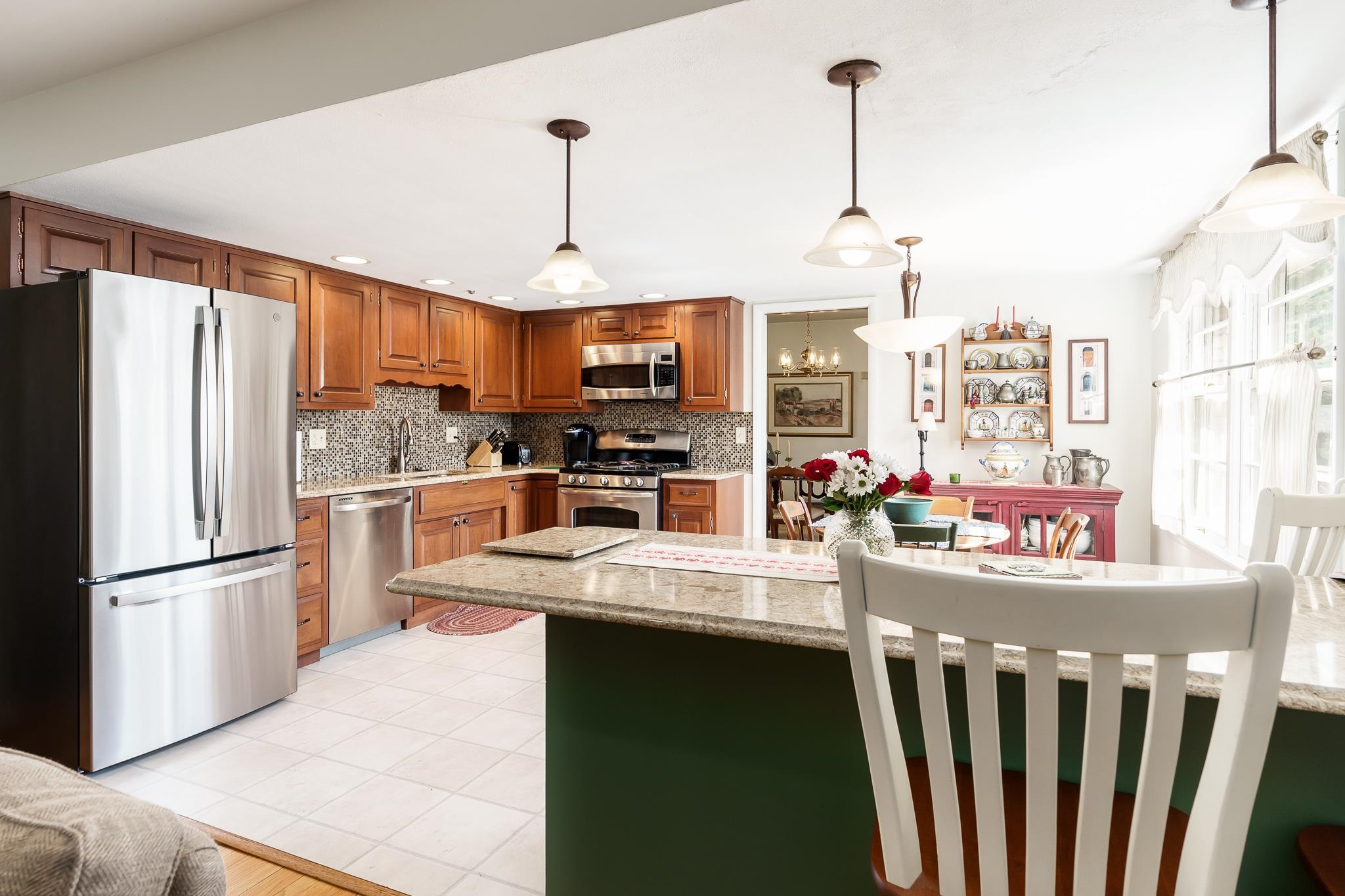 3523 North View Road Rockford, IL 61107 - Photo 17 of 59 a kitchen with stainless steel appliances granite countertop a refrigerator a oven a sink dishwasher and a dining table with wooden floor