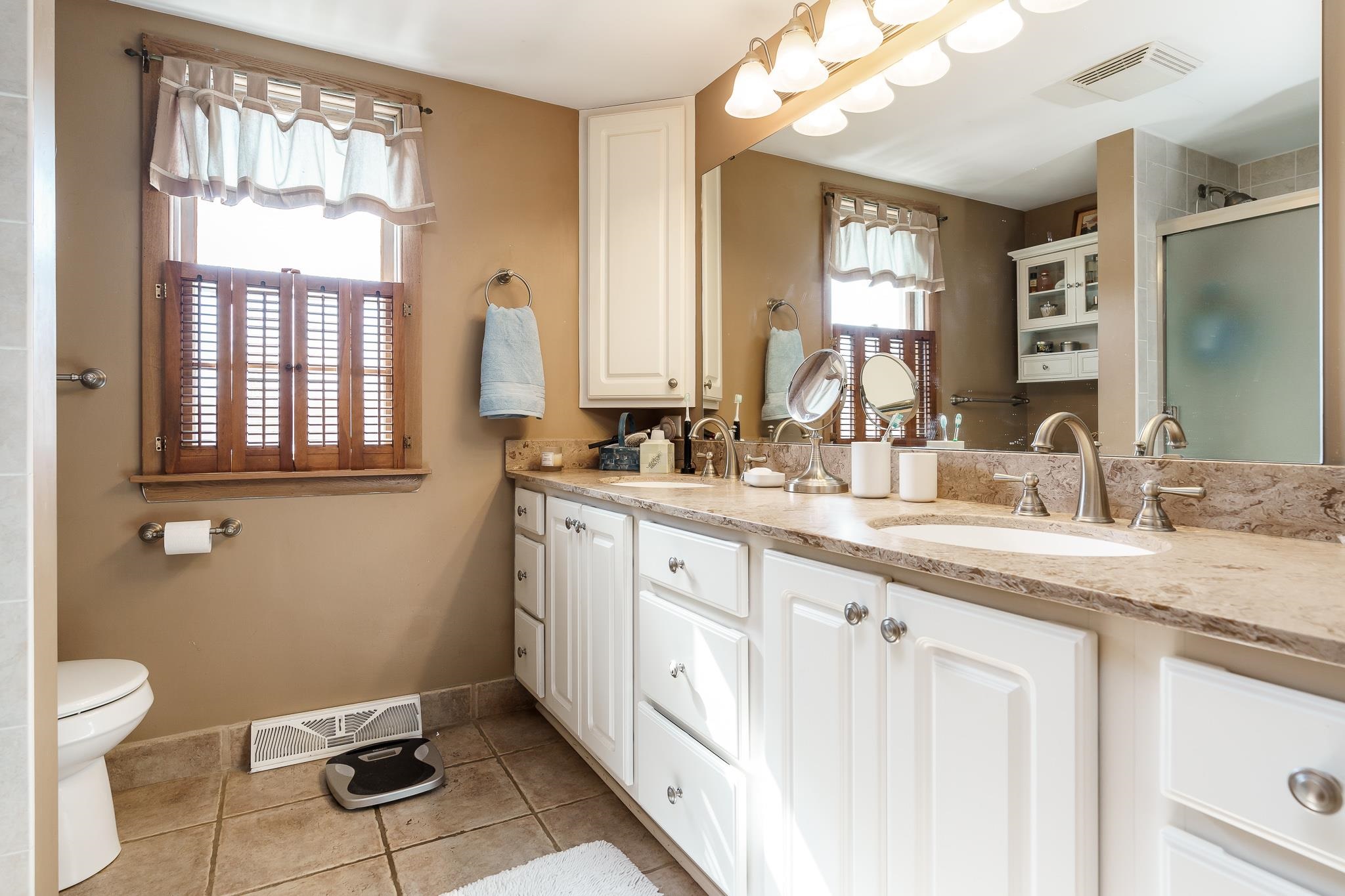 3523 North View Road Rockford, IL 61107 - Photo 35 of 59 a bathroom with a granite countertop sink mirror and a window
