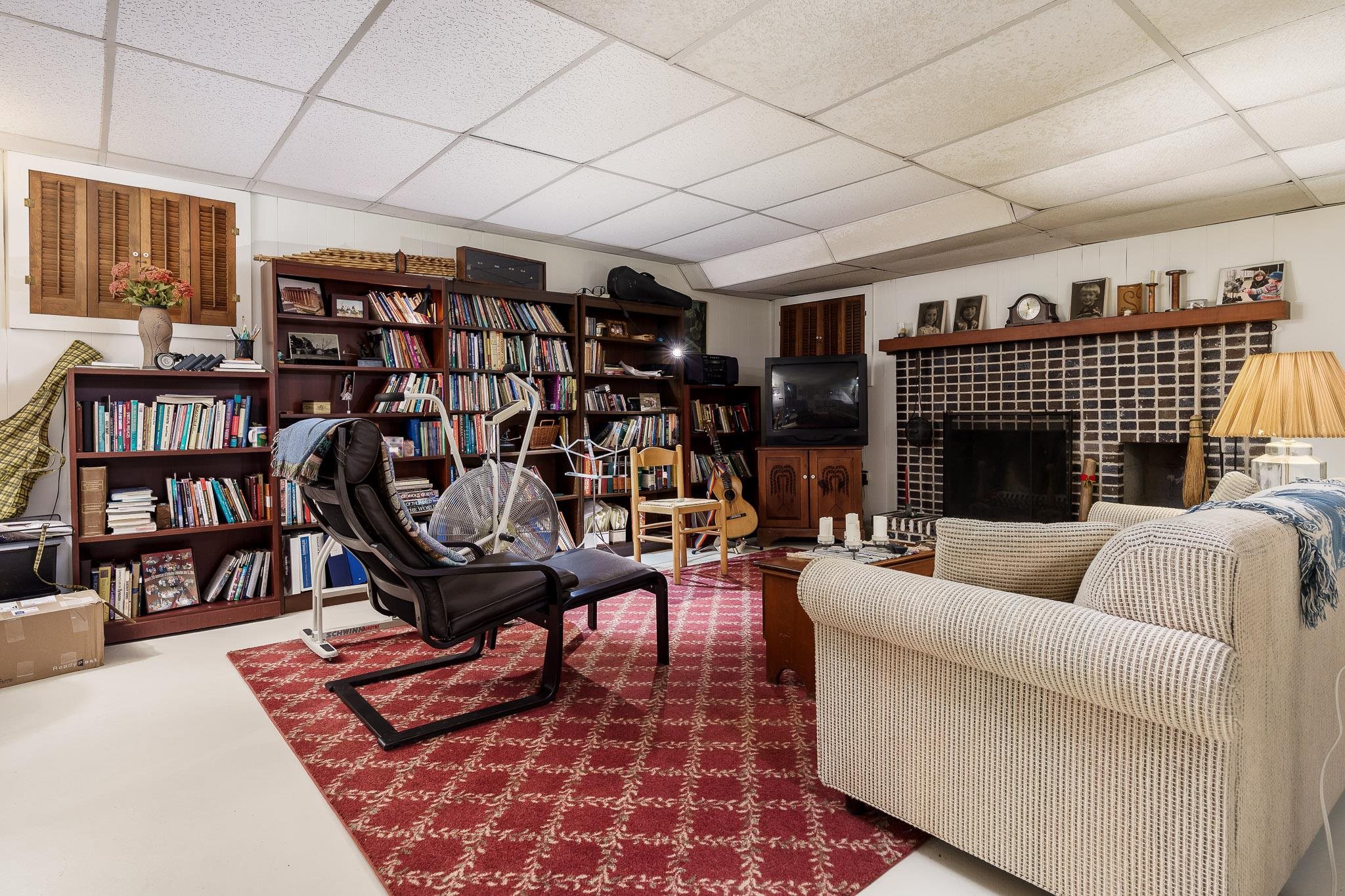 3523 North View Road Rockford, IL 61107 - Photo 43 of 59 a living room with furniture a rug and a book shelf
