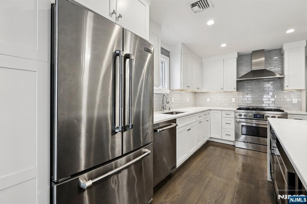 746 Undercliff Avenue, Unit B Edgewater, NJ 07020 - Photo 11 of 50 a kitchen with stainless steel appliances a refrigerator sink and stove
