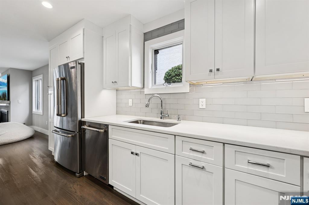 746 Undercliff Avenue, Unit B Edgewater, NJ 07020 - Photo 14 of 50 a kitchen with appliances a sink and cabinets