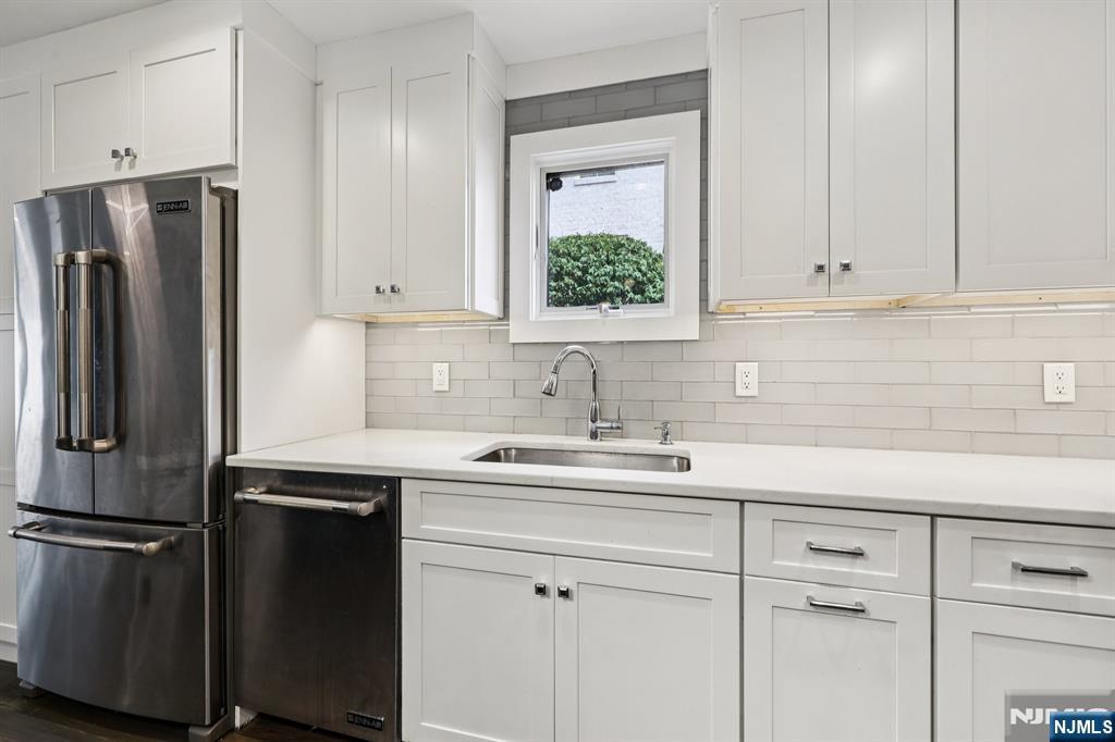 746 Undercliff Avenue, Unit B Edgewater, NJ 07020 - Photo 15 of 50 a kitchen with a sink and a refrigerator