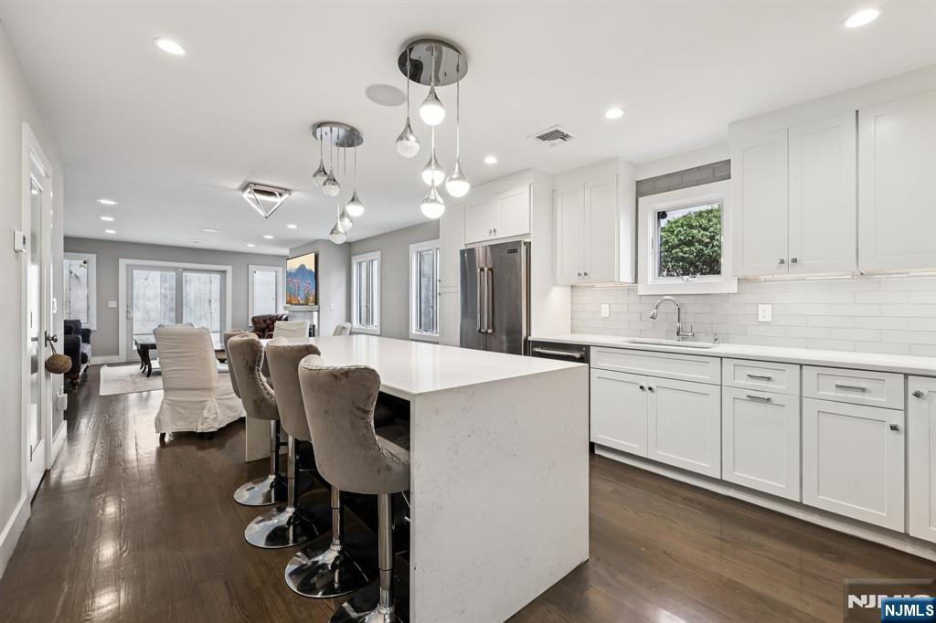 746 Undercliff Avenue, Unit B Edgewater, NJ 07020 - Photo 16 of 50 a large kitchen with a table and chairs in it