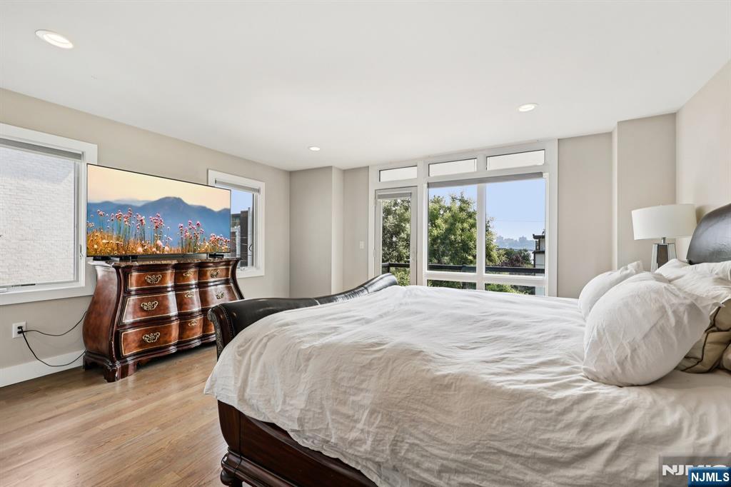 746 Undercliff Avenue, Unit B Edgewater, NJ 07020 - Photo 18 of 50 a bedroom with a bed and wooden floor