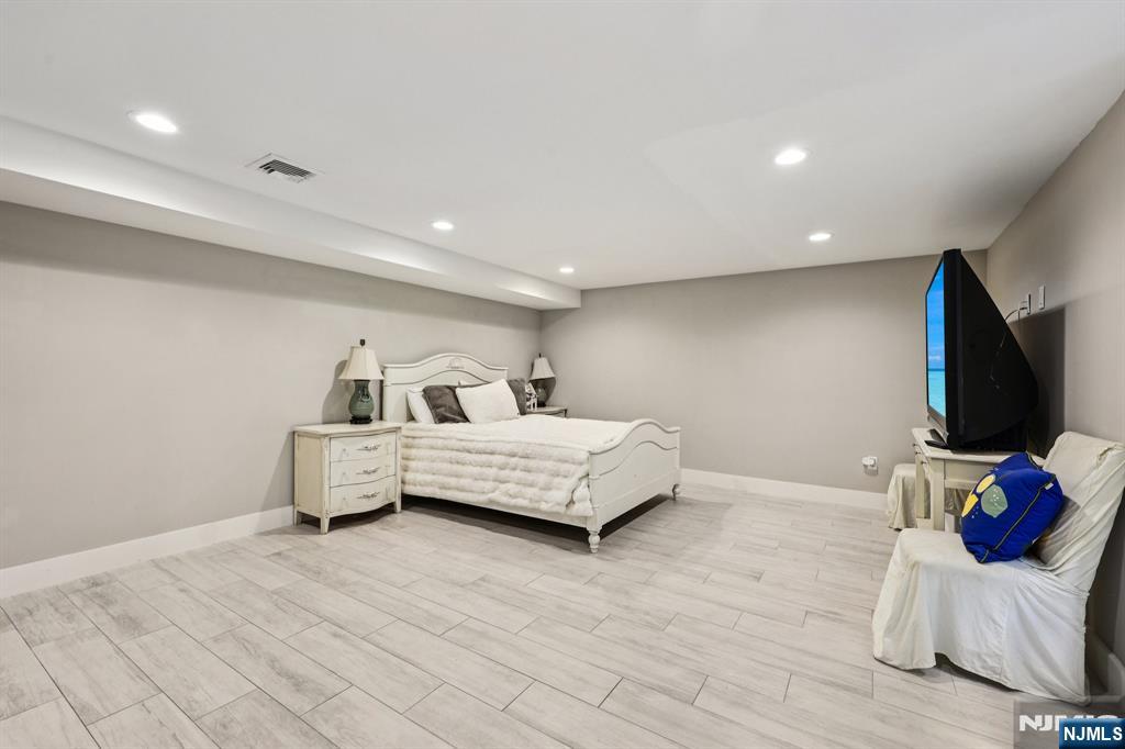 746 Undercliff Avenue, Unit B Edgewater, NJ 07020 - Photo 36 of 50 a bedroom with a bed and a flat screen tv