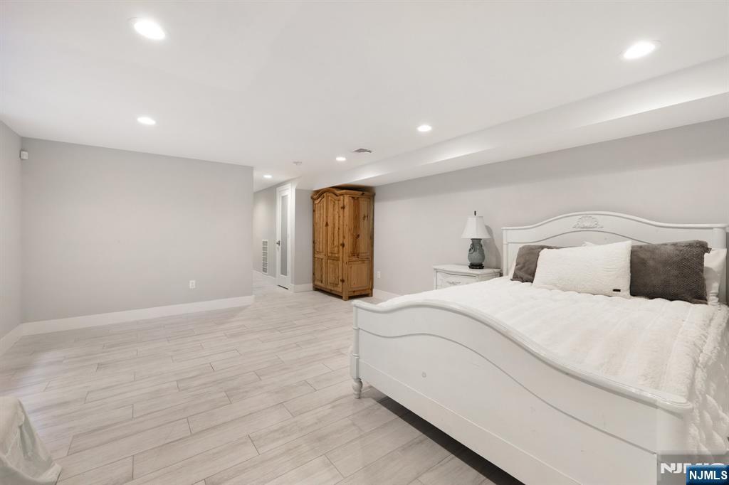 746 Undercliff Avenue, Unit B Edgewater, NJ 07020 - Photo 37 of 50 a spacious bedroom with a bed and a couch