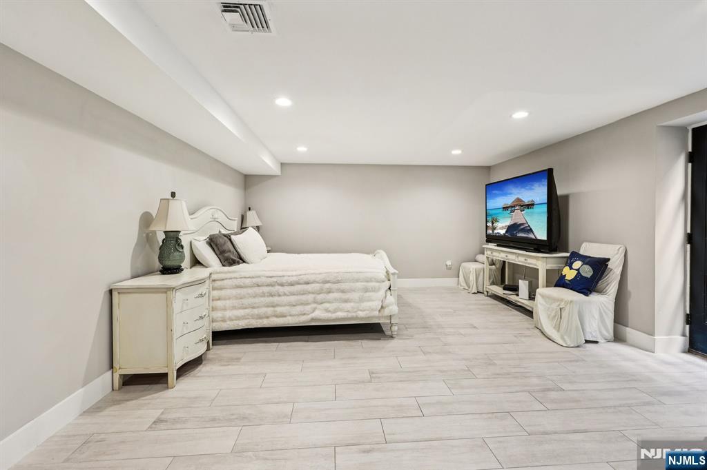 746 Undercliff Avenue, Unit B Edgewater, NJ 07020 - Photo 39 of 50 a bedroom with furniture and a flat screen tv