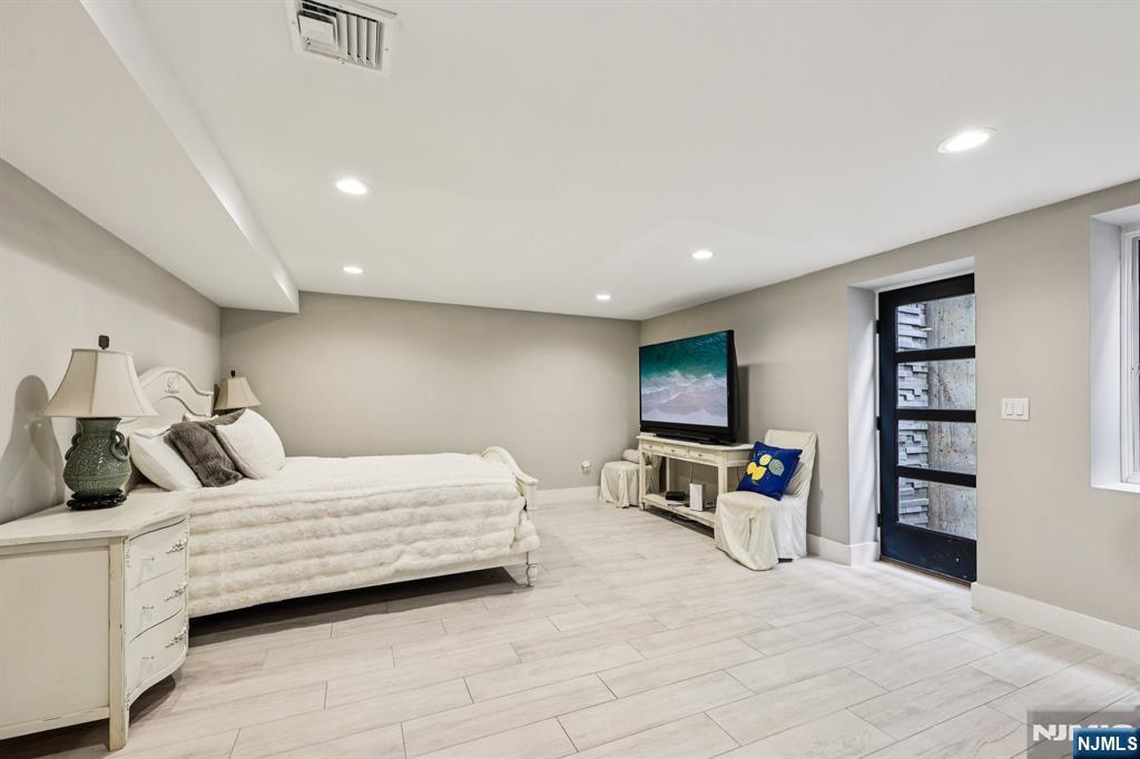 746 Undercliff Avenue, Unit B Edgewater, NJ 07020 - Photo 41 of 50 a bedroom with a bed and a flat screen tv