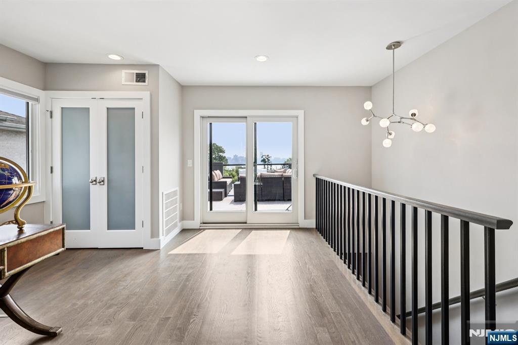 746 Undercliff Avenue, Unit B Edgewater, NJ 07020 - Photo 44 of 50 a view of a room with wooden floor staircase and windows