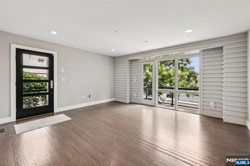 746 Undercliff Avenue, Unit B Edgewater, NJ 07020 - Photo 5 of 50 an empty room with wooden floor and windows