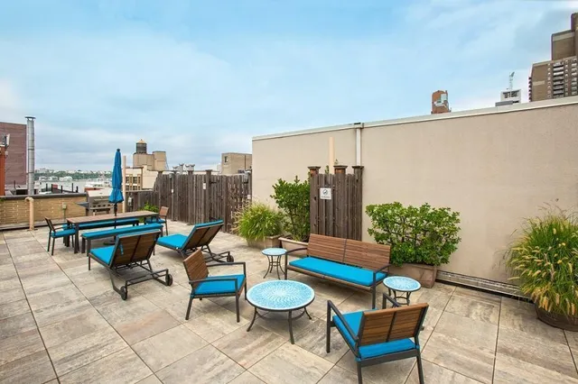 a view of a house with backyard sitting area and garden