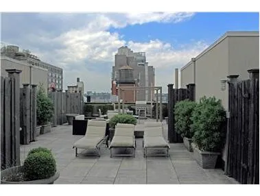 a view of a patio with table and chairs and potted plants