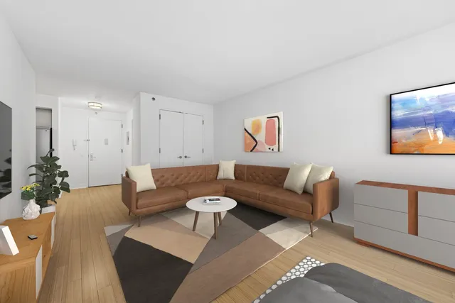 a living room with furniture and a book shelf