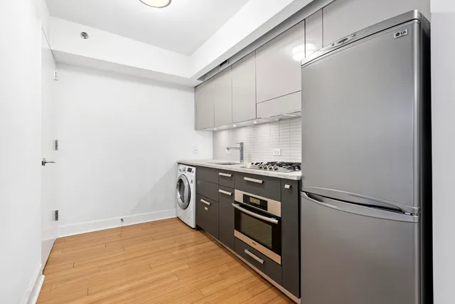 a kitchen with stainless steel appliances a sink stove and refrigerator