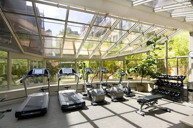 a living room with furniture and a large mirror