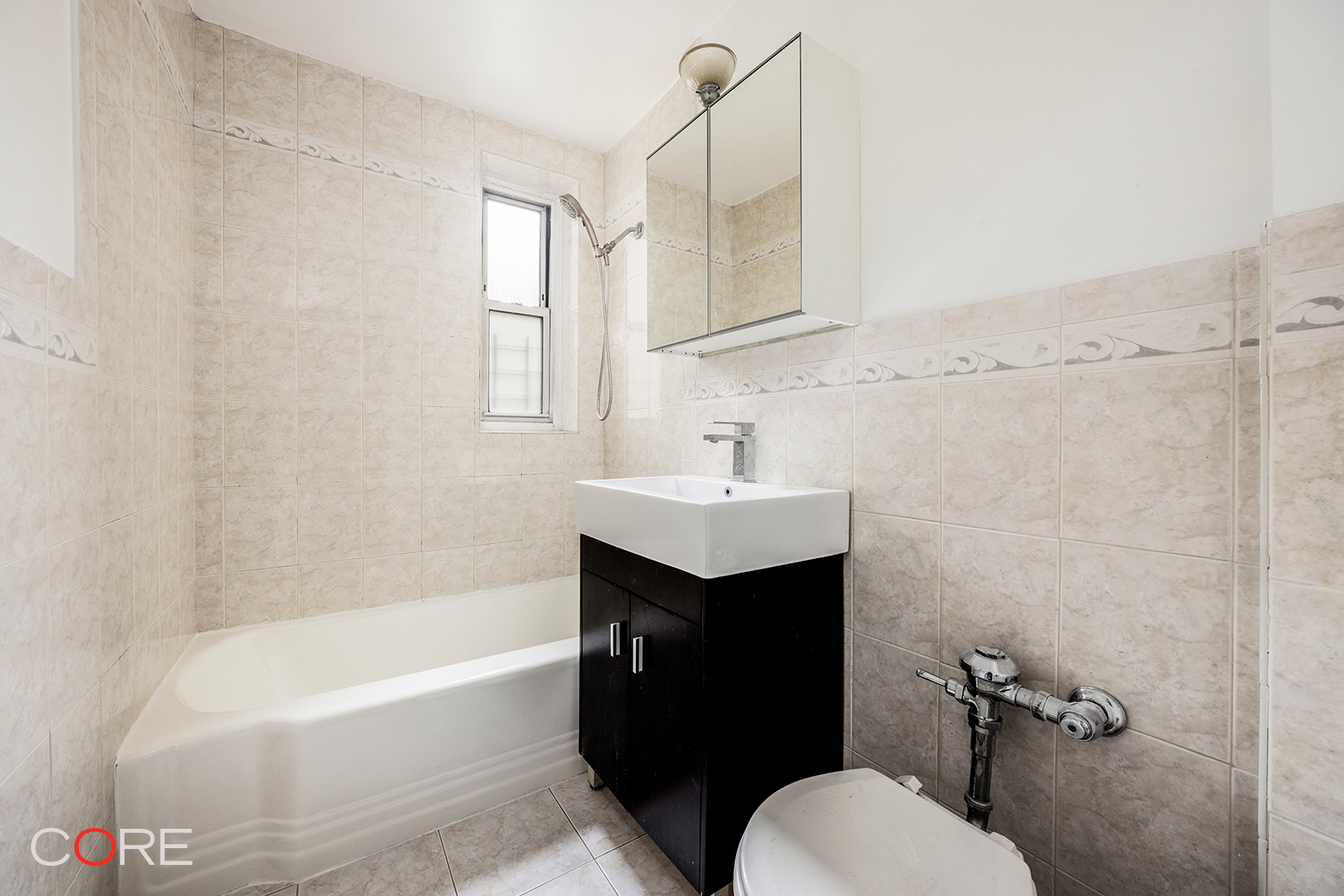 76-10 34th Avenue, Unit 3B Queens, NY 11372 - Photo 5 of 8 a bathroom with a sink toilet and bathtub