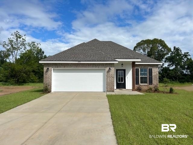 Single story home with concrete driveway, brick siding, a garage, and a front yard