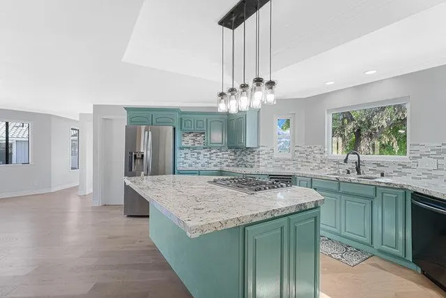 an empty room with chandelier fan