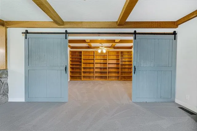 a view of room with hardwood floor and ceiling fan