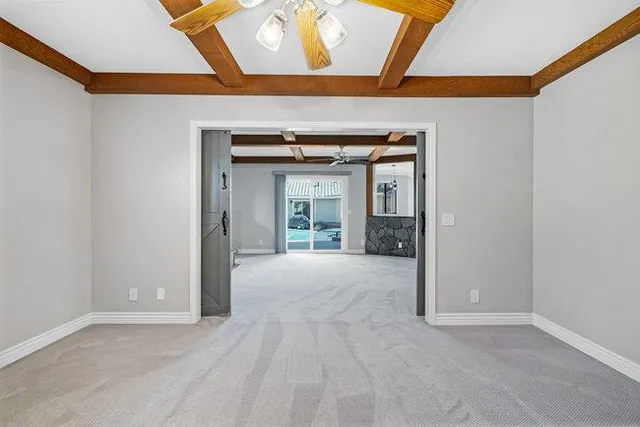 an empty room with closet and a chandelier fan