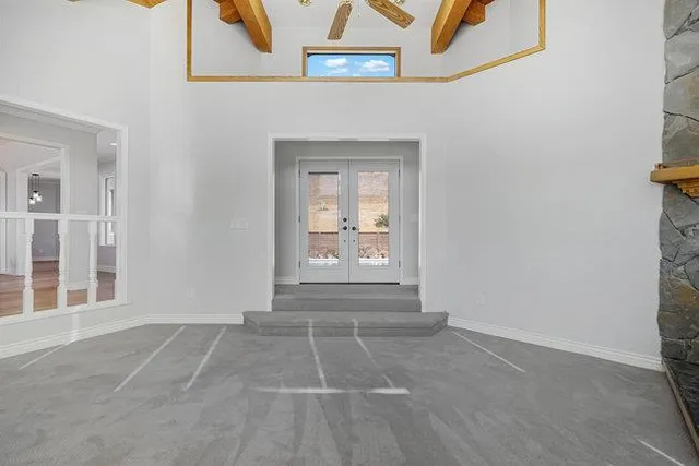 a view of a lake with a yard and large trees