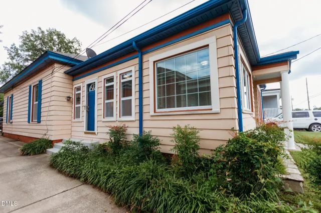 a view of a house with potted plants