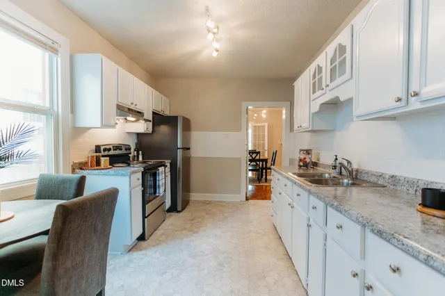 a kitchen with granite countertop lots of counter top space and stainless steel appliances