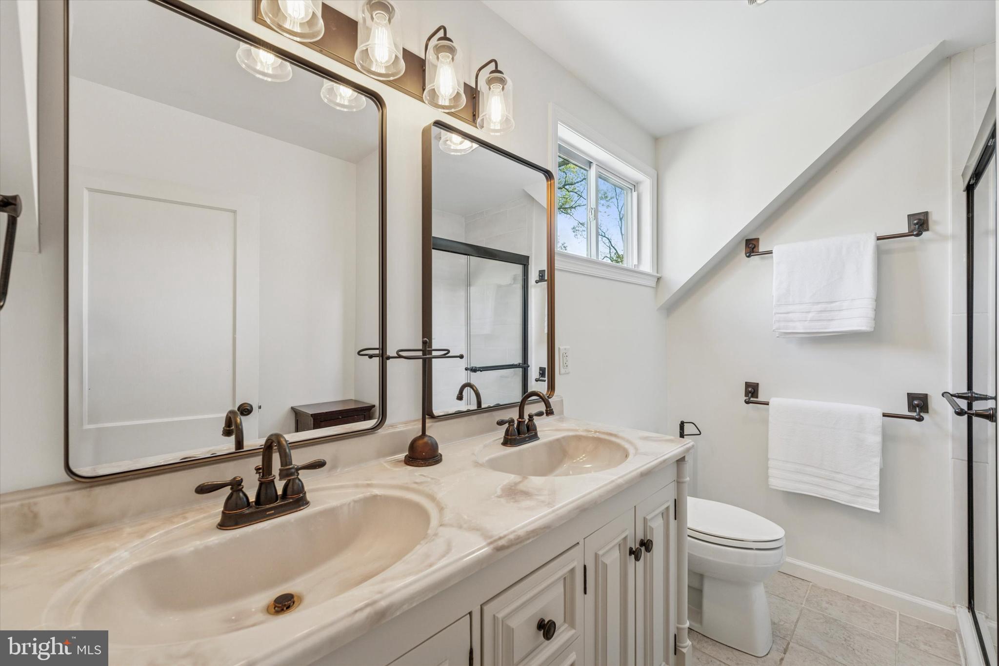 447 Conestoga Road Wayne, PA 19087 - Photo 14 of 22 a bathroom with a sink a toilet and a mirror