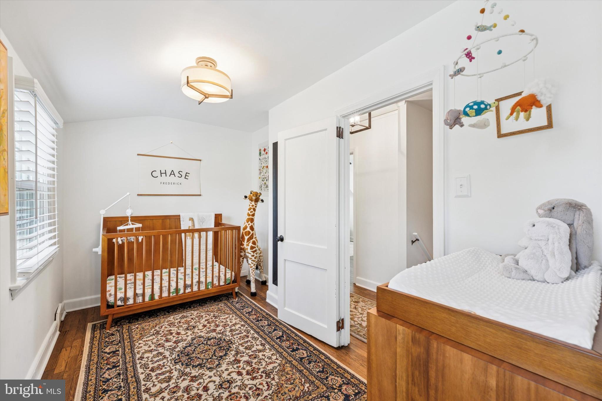 447 Conestoga Road Wayne, PA 19087 - Photo 16 of 22 a bedroom with a baby crib and a window