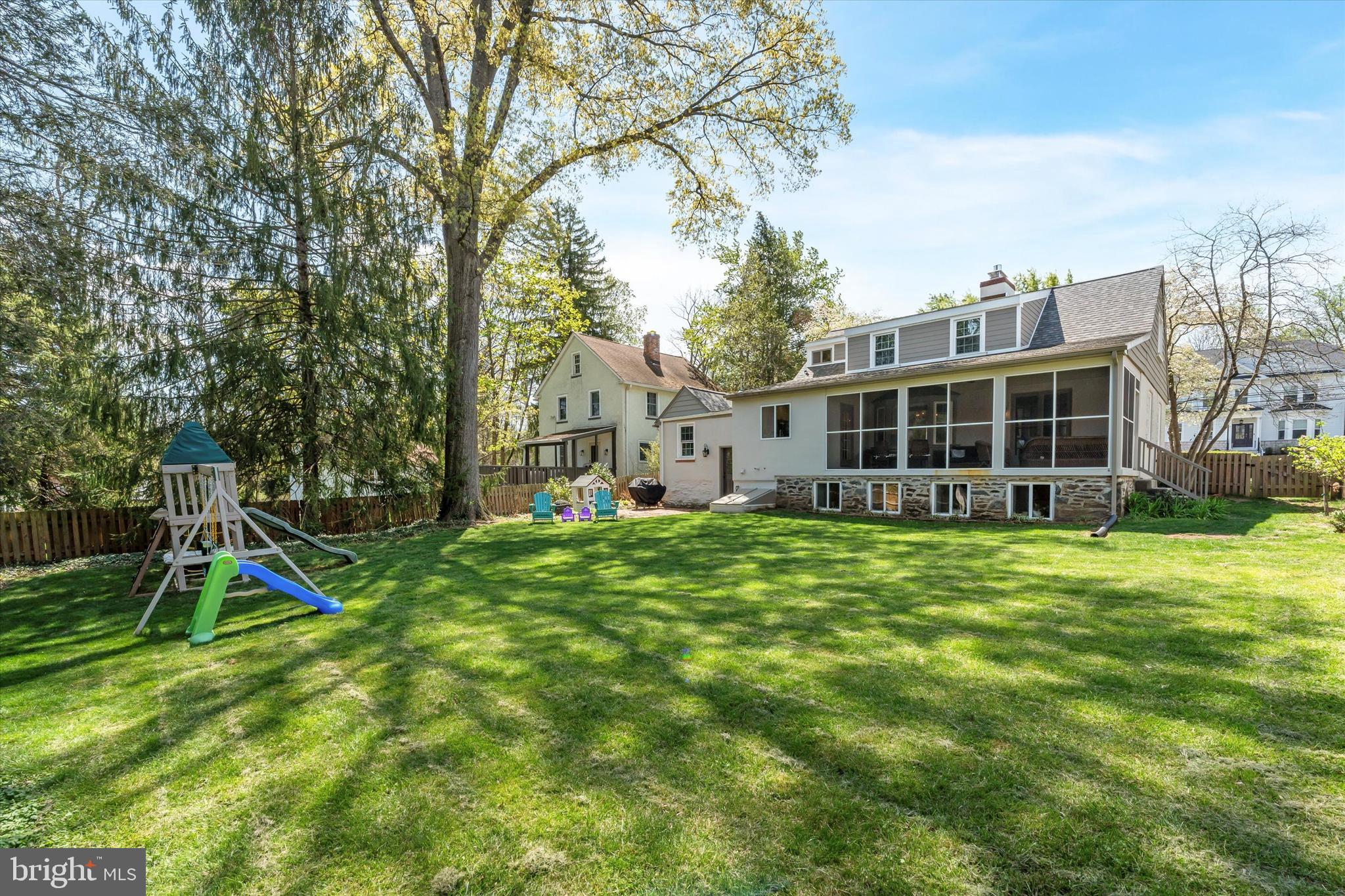 447 Conestoga Road Wayne, PA 19087 - Photo 20 of 22 a view of a house with a backyard and a tree