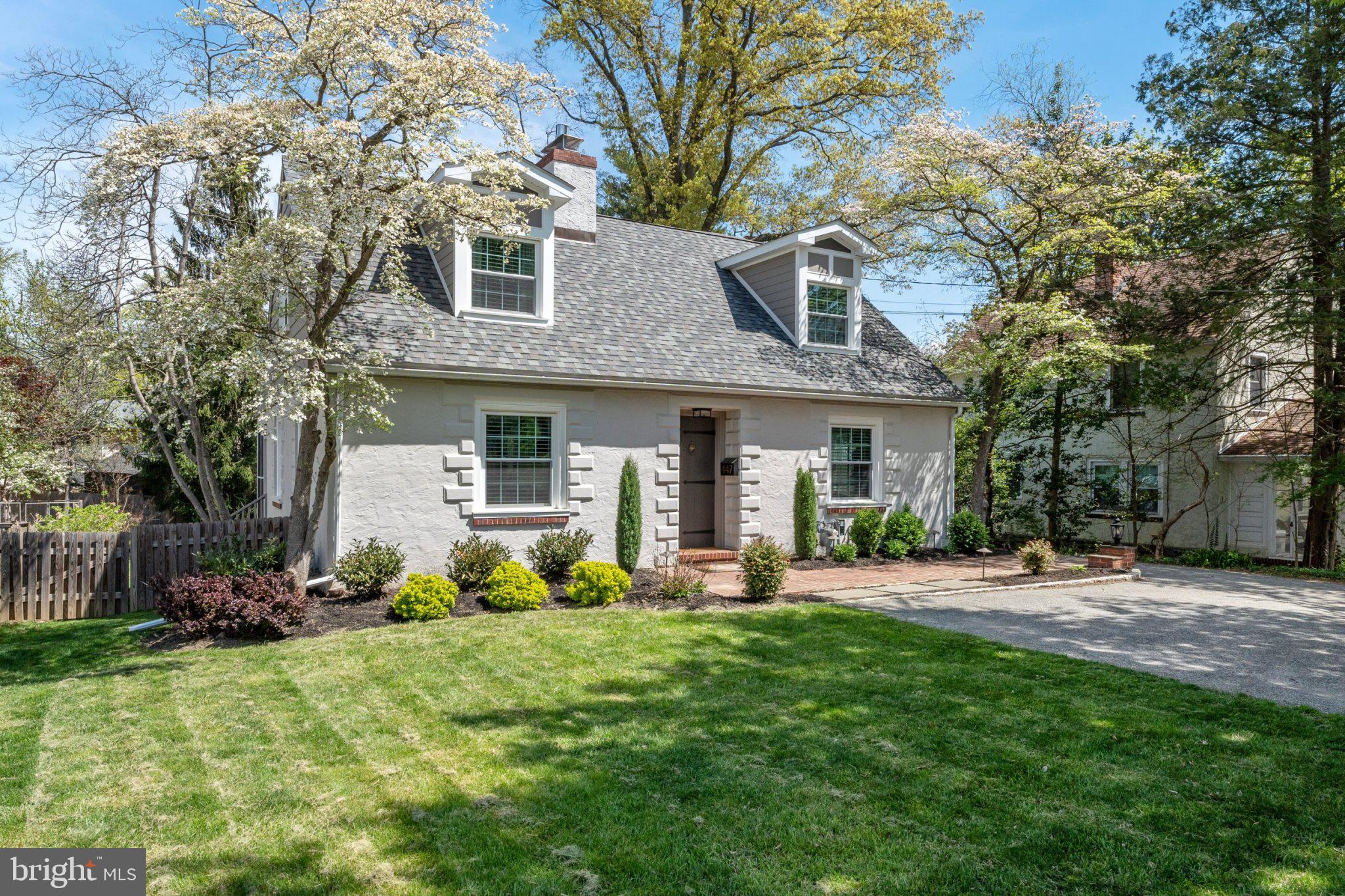 447 Conestoga Road Wayne, PA 19087 - Photo 2 of 22 a front view of a house with a yard and trees