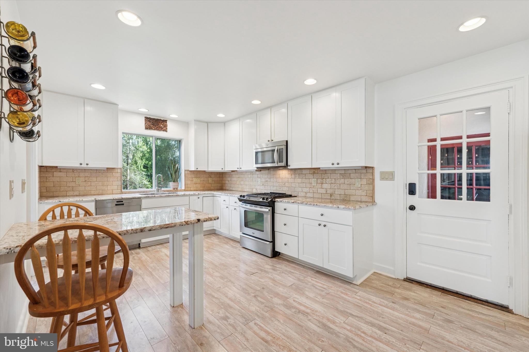 447 Conestoga Road Wayne, PA 19087 - Photo 7 of 22 a kitchen with granite countertop wooden floors and cabinets