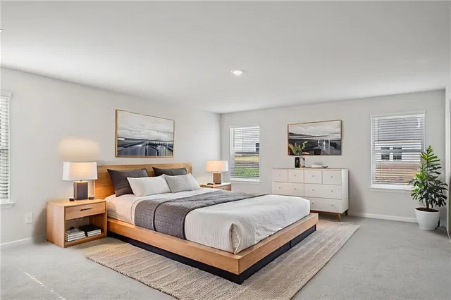 a bedroom with a bed a mirror and table