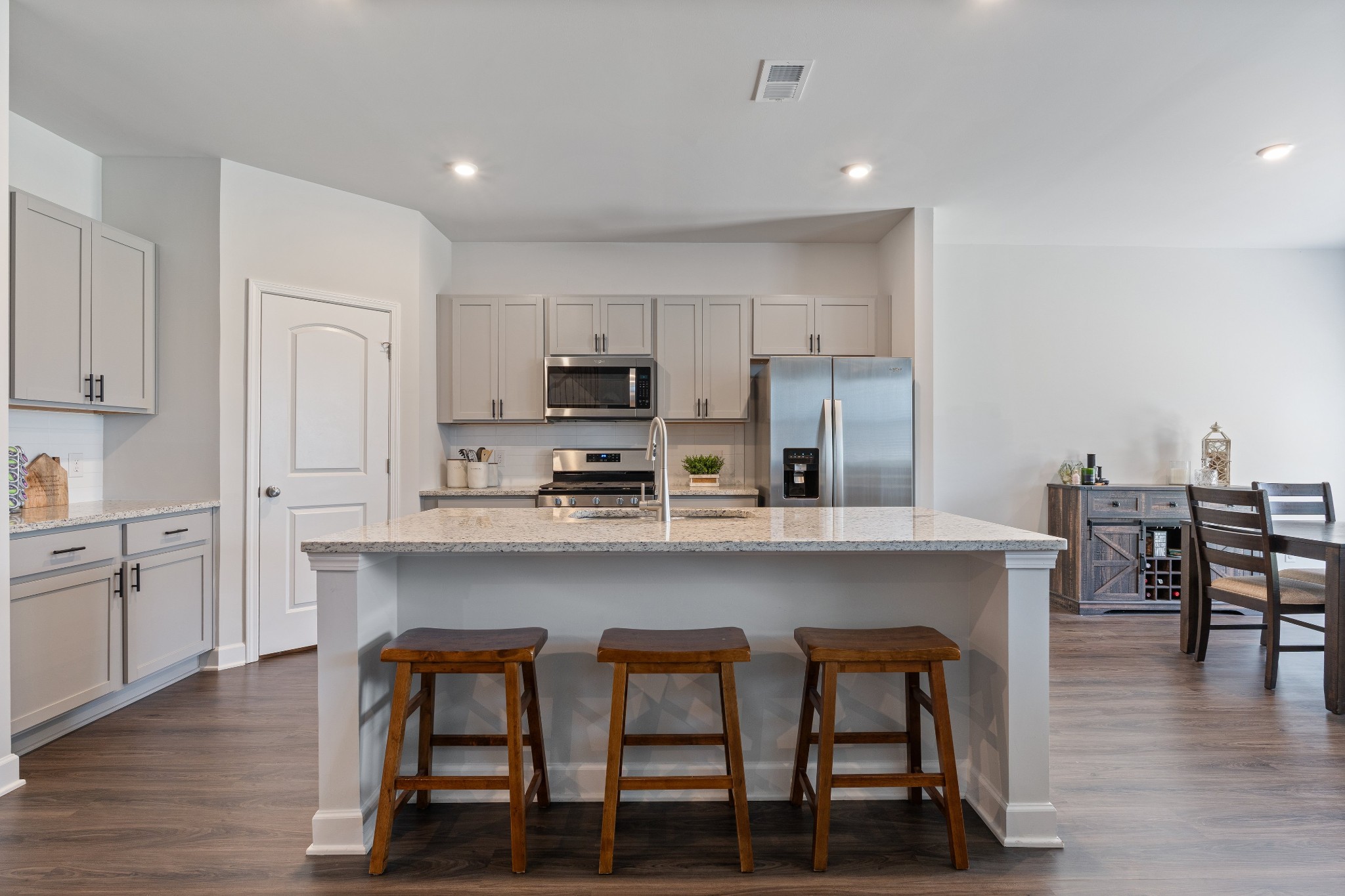 106 Pekka Drive Lebanon, TN 37087 - Photo 8 of 24 a kitchen with stainless steel appliances a dining table chairs microwave and sink